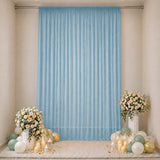 Elegant pastel balloon and floral backdrop with blue curtain for celebration décor
