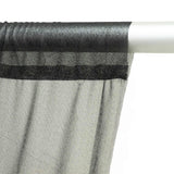 Sheer black and gray striped curtain on white rod