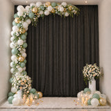 Elegant pastel balloon and floral party backdrop with candles and vases