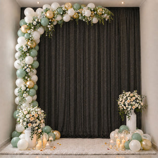 Elegant pastel balloon and floral party backdrop with candles and vases