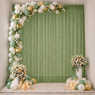 Elegant green and gold balloon floral party backdrop with candles and flowers