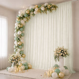 Pastel balloon and floral photo backdrop with candles for elegant celebration