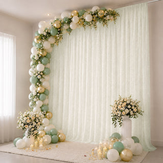 Pastel balloon and floral photo backdrop with candles for elegant celebration