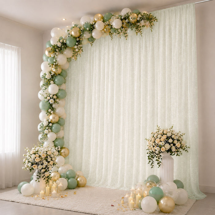 Pastel balloon and floral photo backdrop with candles for elegant celebration
