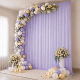 Lavender and gold balloon arch with floral backdrop for elegant party decor