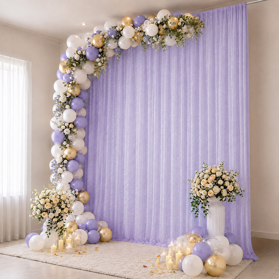 Lavender and gold balloon arch with floral backdrop for elegant party decor