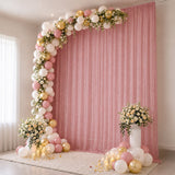 Pink and gold balloon arch with floral backdrop for elegant party decor