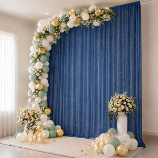Elegant balloon arch with flowers and blue backdrop for event decor