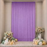 Lavender party backdrop with floral arrangements and pastel balloons