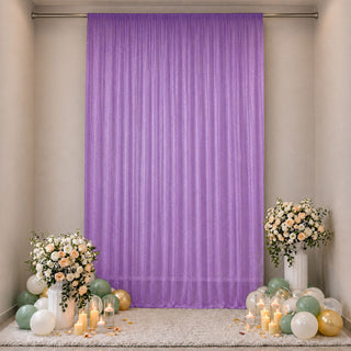 Lavender party backdrop with floral arrangements and pastel balloons
