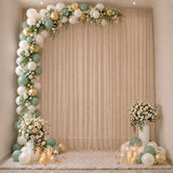 Elegant balloon and floral photo backdrop with candles and pastel decor