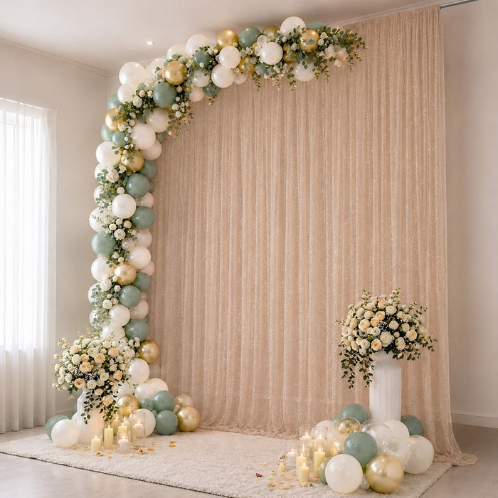 Elegant pastel balloon and floral party backdrop with candles and curtains