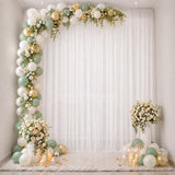Elegant balloon and floral party backdrop with candles and white draping