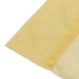 Close-up of a yellow textured foam sponge on white background
