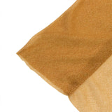 Close-up of gold glitter fabric texture on white background