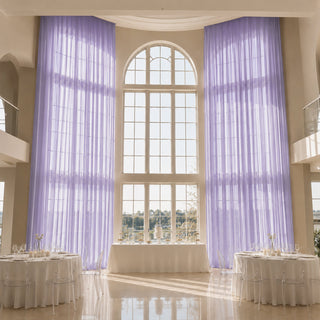 Elegant lavender drapes in a grand wedding reception hall with tall arched windows