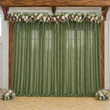 Green sheer wedding backdrop with floral garland and wooden arch frame
