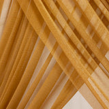 Golden sheer fabric with layered diagonal folds and soft light reflections