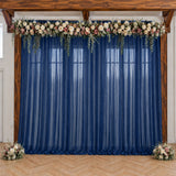 Navy blue wedding backdrop with floral garland and wooden frame