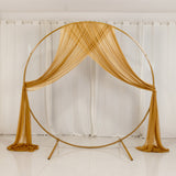 Gold circular wedding backdrop with draped sheer fabric and white curtains