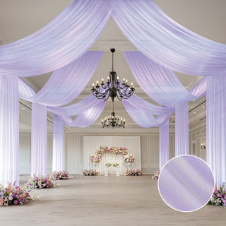 Elegant purple drapery in a beautifully decorated event space with floral arrangements.