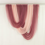 Pink and blush sheer curtain panels draped on rod