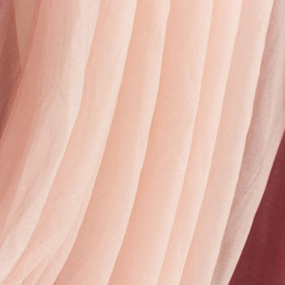 Soft pink tulle fabric draping elegantly in layered textures.