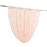 Sheer peach curtain panel hanging on rod
