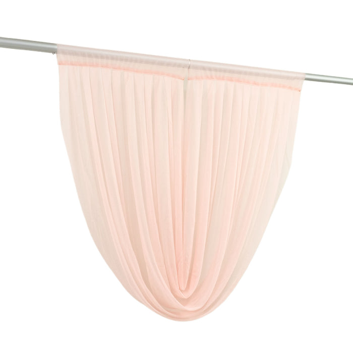 Sheer peach curtain panel hanging on rod