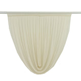 Pleated sheer curtain in soft cream color hanging from a rod