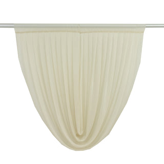 Pleated sheer curtain in soft cream color hanging from a rod