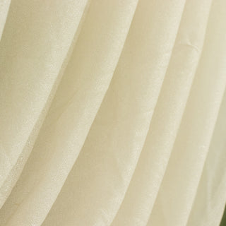 Shimmering ivory fabric draping with soft folds and texture.