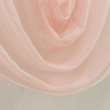 Pink sheer fabric draped elegantly on a light backdrop.