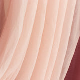 Soft pink tulle fabric draped elegantly, showcasing delicate texture.