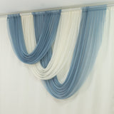 Blue and white sheer curtains draped elegantly in soft waves.