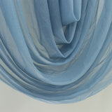 Sheer blue fabric draped elegantly, showcasing its soft texture and flow.