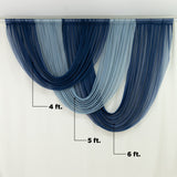 Elegant blue and gray curtain drapery on a light backdrop.