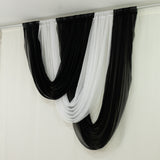 Black and white drapery fabric arranged in elegant swags.