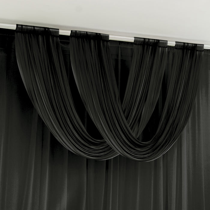 Black draped curtains in a modern interior setting.