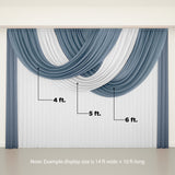 Blue and white draped curtain fabric hanging elegantly. 