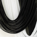 Close-up of black and white sheer curtains with flowing layered drape
