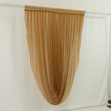 Gold sheer curtain hanging in studio display with backdrop
