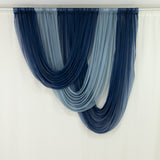 Blue and navy sheer curtain draped elegantly in folds.