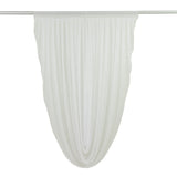 White sheer drapery panel hanging in graceful folds 