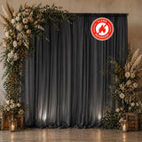 Elegant floral event backdrop with dark curtains and lanterns