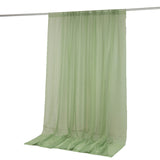 Light green sheer curtain panel on rod, floor-length drape