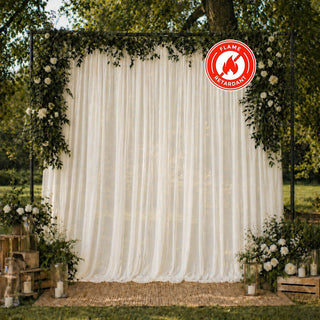 Elegant outdoor wedding backdrop with floral arch and flame-retardant drapery