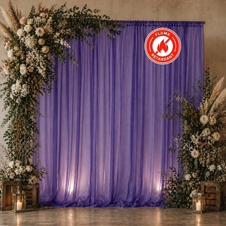 Purple floral wedding backdrop with candles and fire-retardant drape