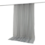 Sheer gray curtain panel hanging on a curtain rod