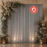 Elegant floral wedding backdrop with gray drapes and lantern candles